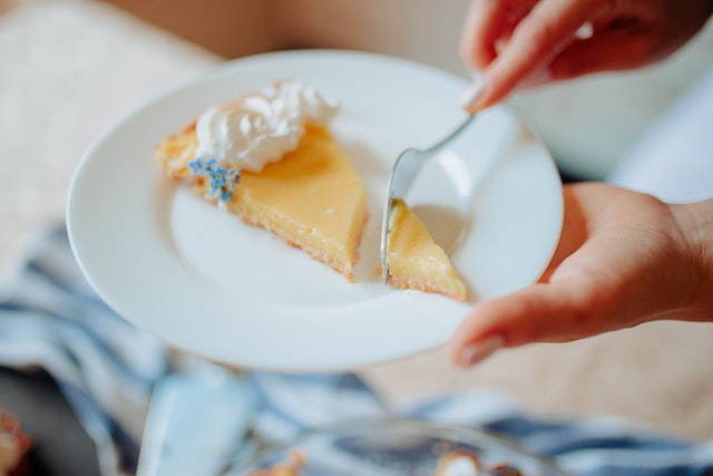 a slice of pie with some whipped cream